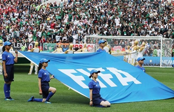 Chinese caddies hold FIFA flag before opening match of 2018 FIFA World Cup