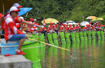 Contestants take part in fishing competition in central China's Hubei