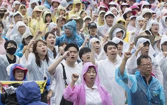 韓國民眾冒雨參加大規(guī)模和平游行示威